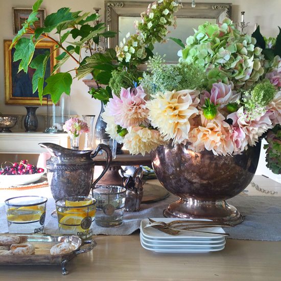 Summer flowers in antique silver containers