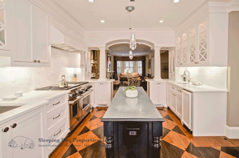 White kitchen with stained checkerboard floor 