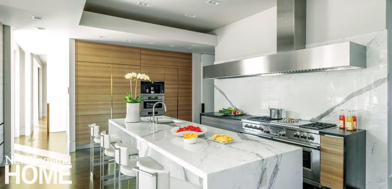 Galleries New England Home Magazine Wood Grained Eggersmann Cabinetry Hides Major Liances And Provides Contrast To The Monumental Marble Kitchen Island
