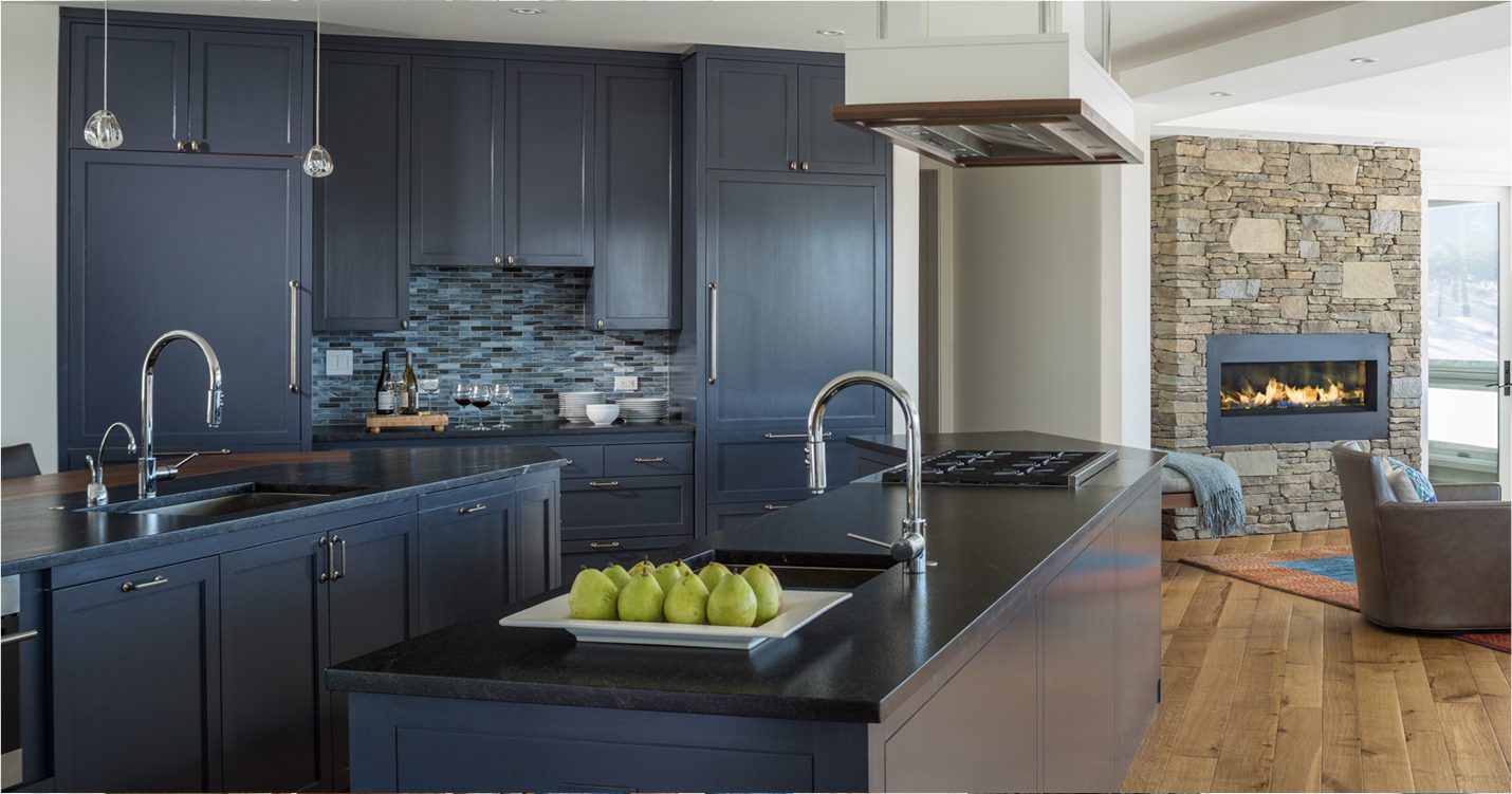 Kitchen with dark gray cabinets designed by Emily Pinney